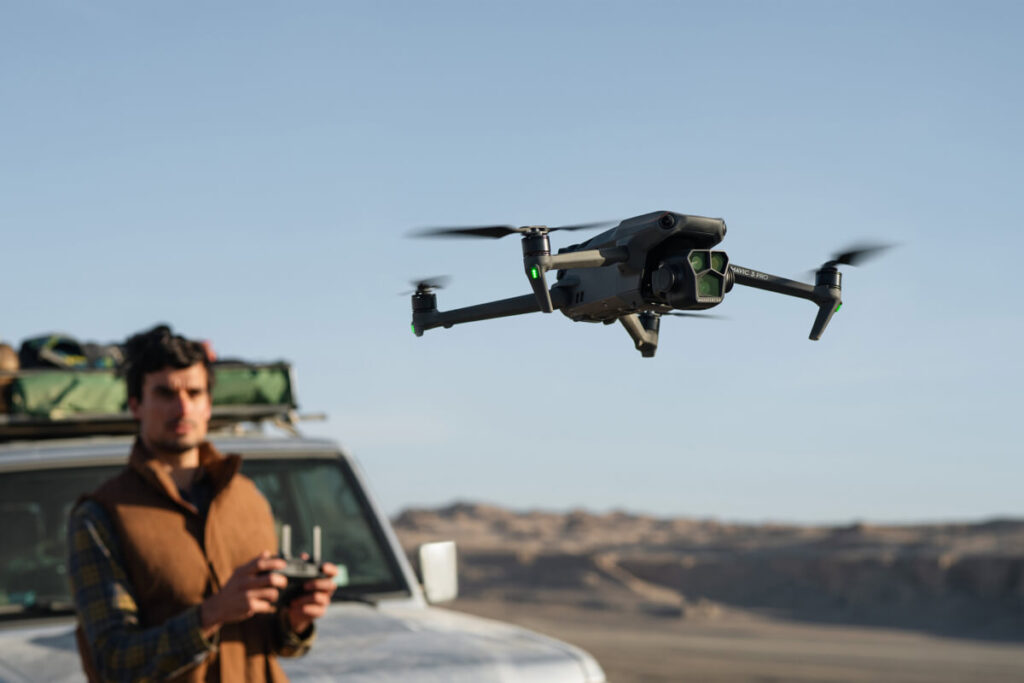 A front view of a person operating a long range drone with a remote controller
