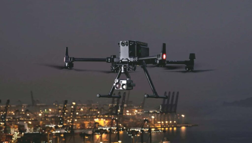 A night vision drone hovering through the city