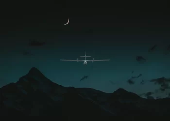 A night vision drone hovering in the sky at night time