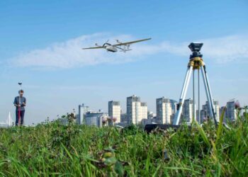 a drone flying above the field for surveying