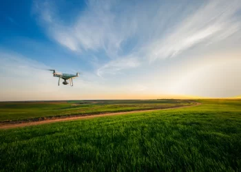 drone flying over green field