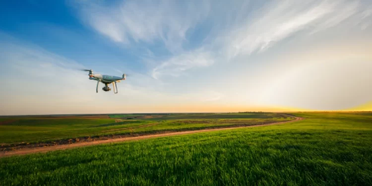drone flying over green field