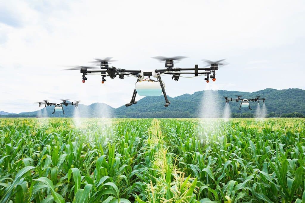 drones spraying on green fields