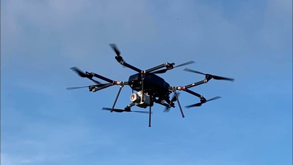 sky front black drone in flight