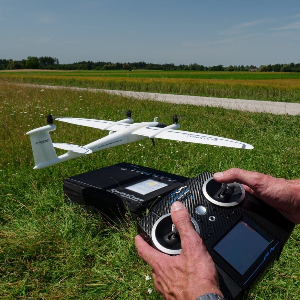 someone operating quantam systems drone in a field