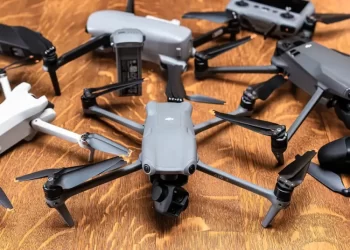 variety of drones placed on a wooden surface