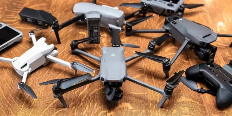 variety of drones placed on a wooden surface