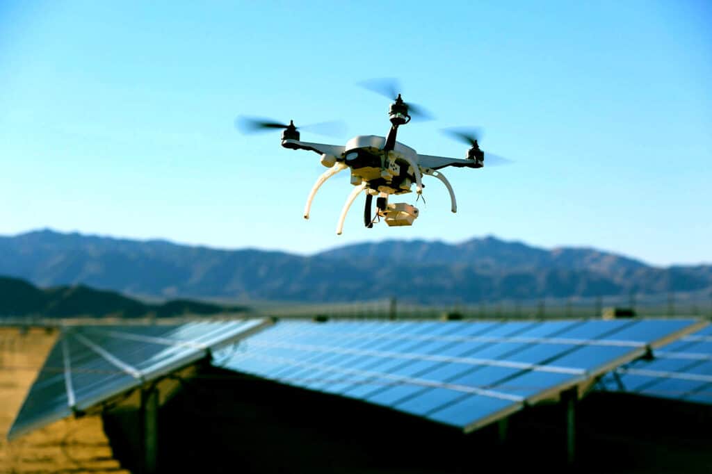 A view of a drone hovering over a solar panel