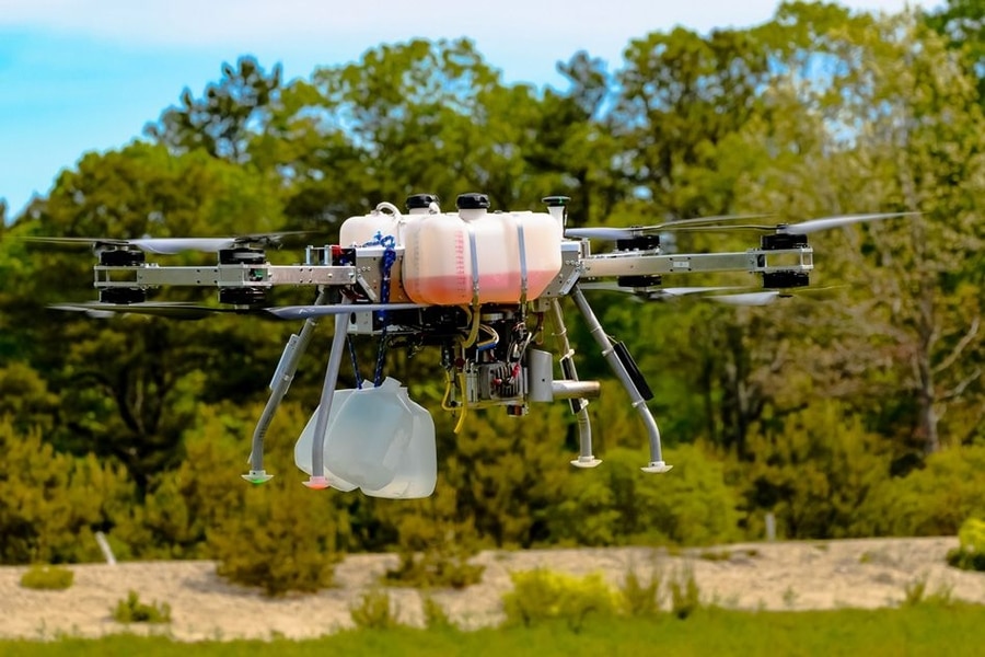 A view of a large gas drone hovering over a field