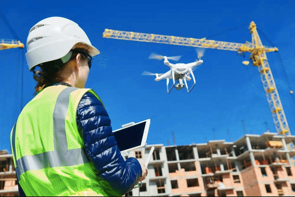 a women constructor is operating a drone on a site