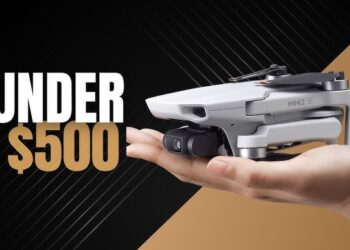 a man holding the drone in his hand