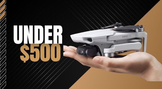 a man holding the drone in his hand