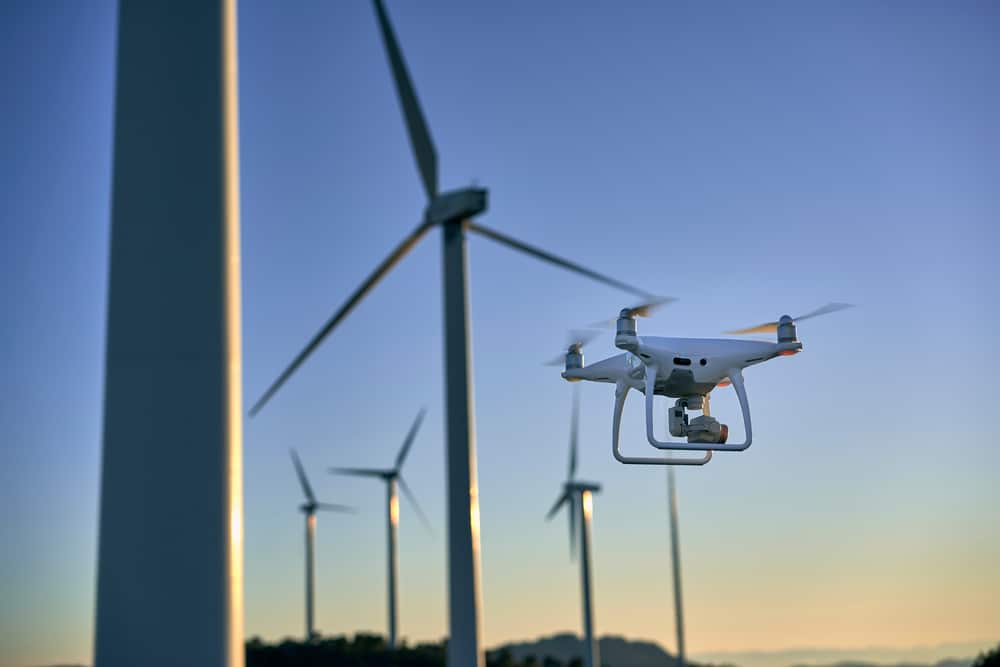 Drone Flying Over A Background Of Wind Turbines Drone During